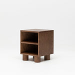 Wooden nursery bedside table with two shelves on a white background