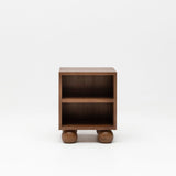 Wooden walnut bedside table with ball feet for nursery.