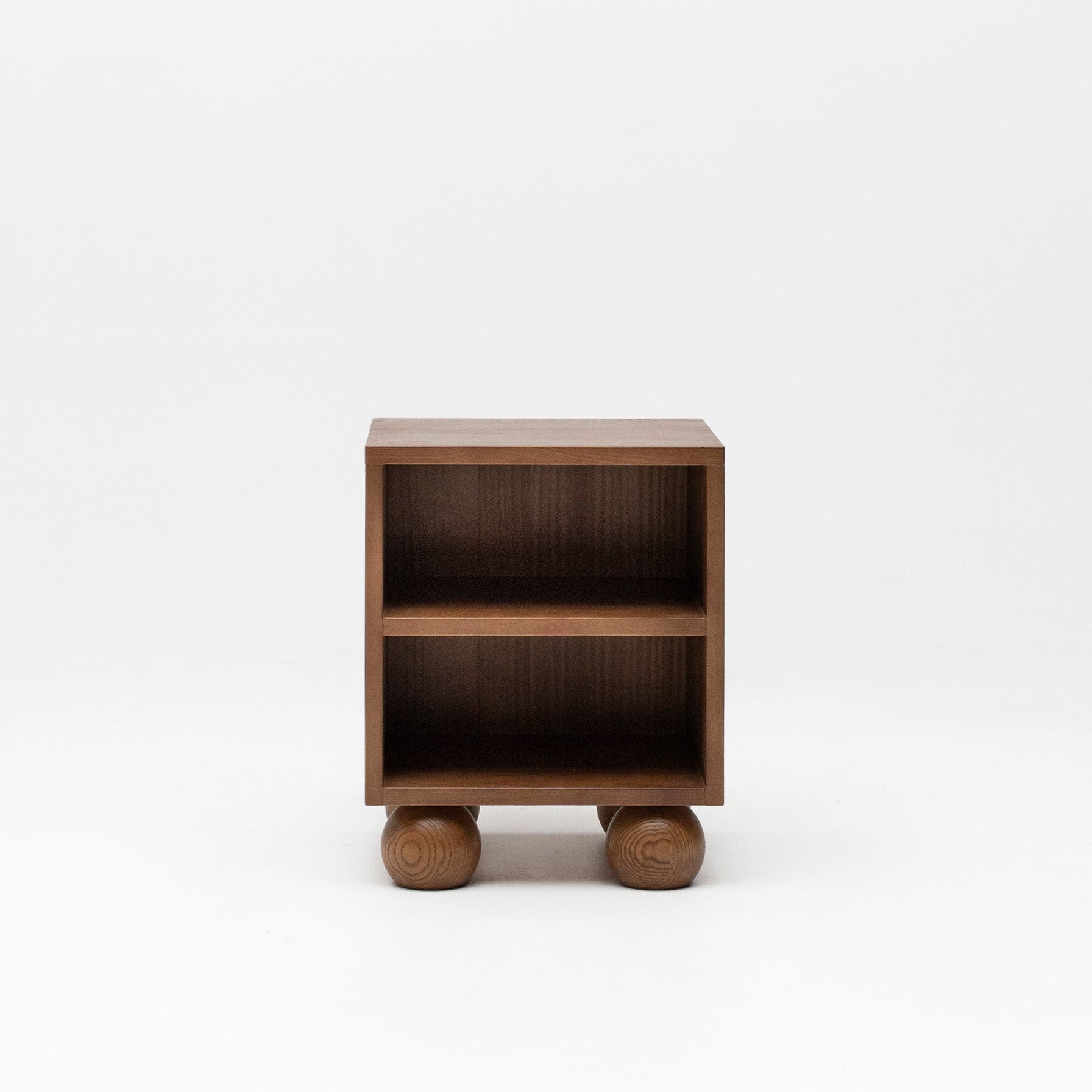 Wooden walnut bedside table with ball feet for nursery.