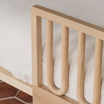 Closeup of Arche Ashwood Toddler Bed Side Rail on a single children's bed with a white duvet