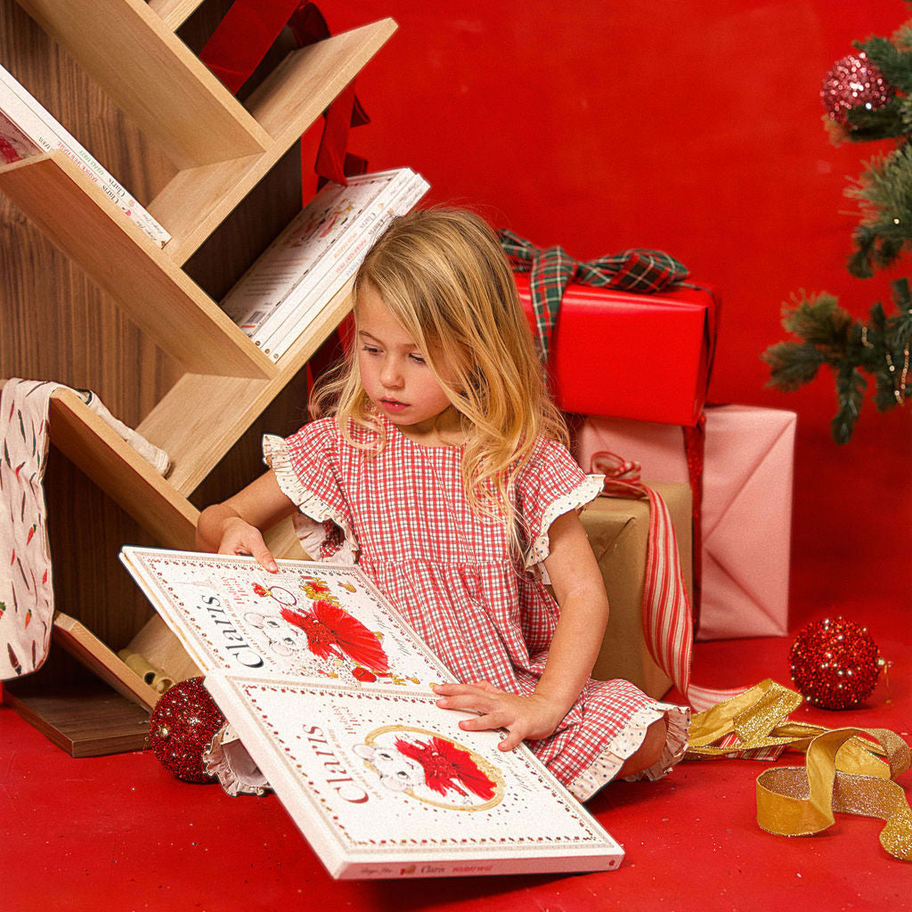 Artie Bookshelf in the background behind a young girl reading a book
