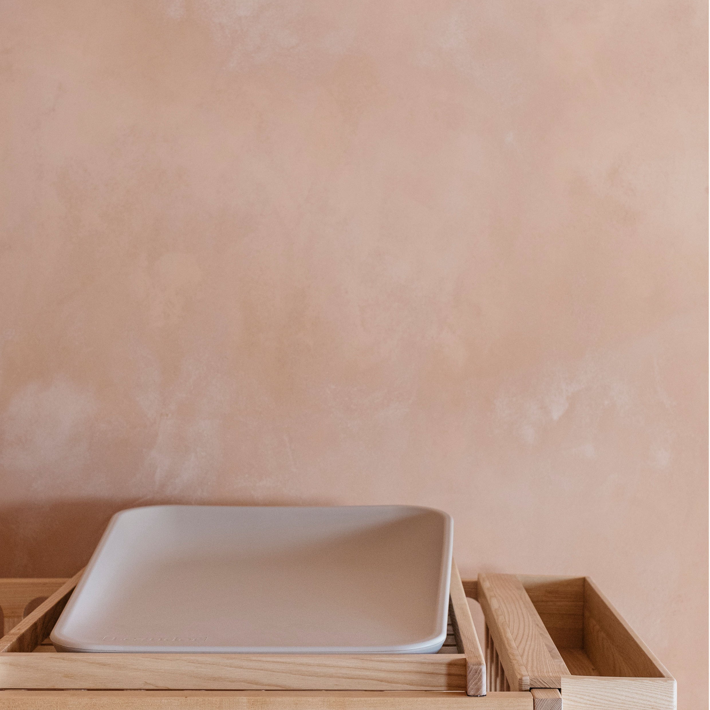 The Space Saver on top of Ashwood cot with a Leander baby change matt on top and Ashwood caddy on the side of the cot.