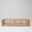 Solid Ashwood children's floor bed showing natural timber frame on white background