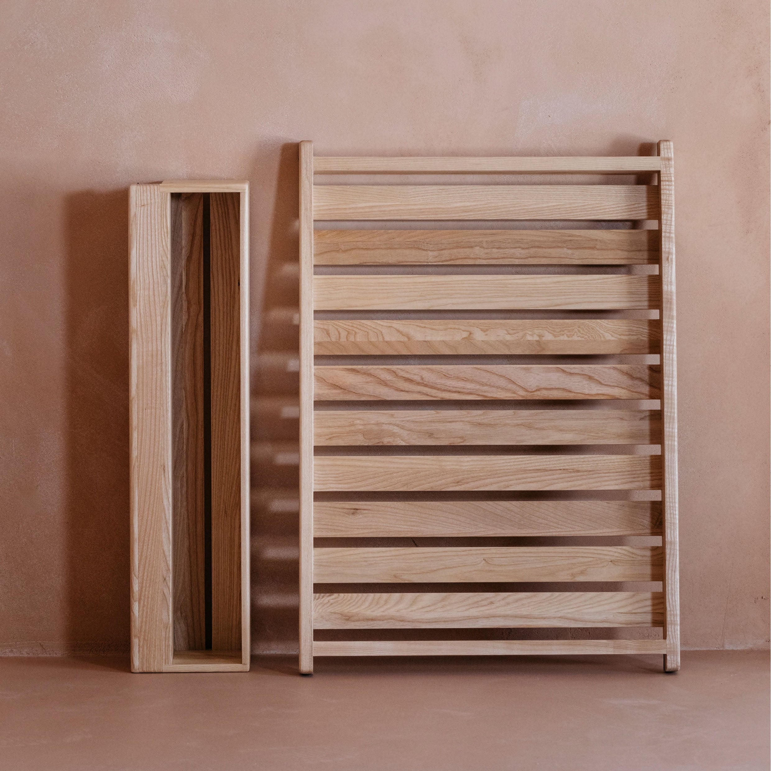 Ccot change table Ashwood Space Saver and Caddy against a pink-beige wall