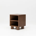 Wooden nursery bedside table with two shelves on a white background