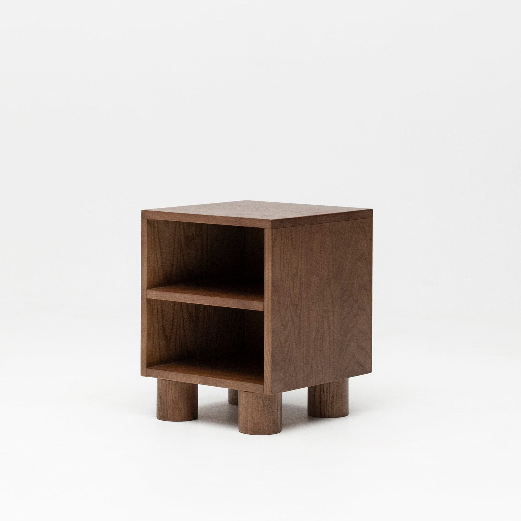 Wooden nursery bedside table with two shelves on a white background