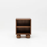 Wooden walnut bedside table with ball feet for nursery.