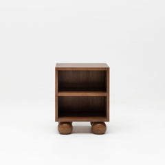Wooden walnut bedside table with ball feet for nursery.