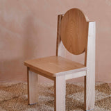 Side view of Hennie Ashwood kids chair on natural rug in warm toned child's room