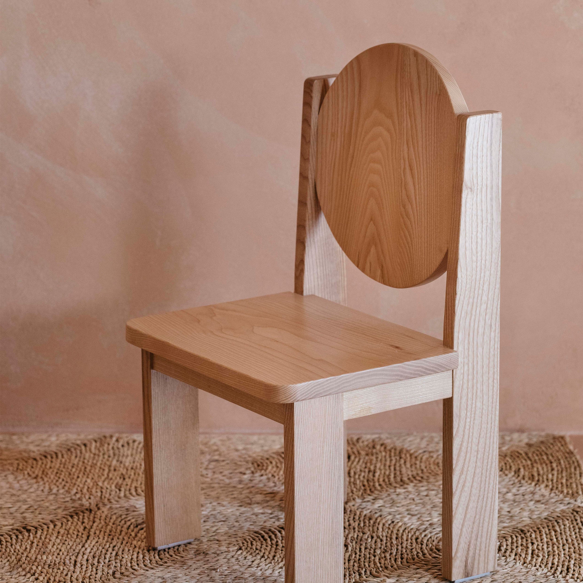 Side view of Hennie Ashwood kids chair on natural rug in warm toned child's room