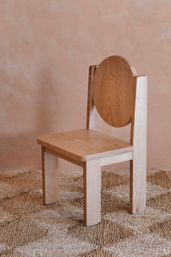 Side view of Hennie Ashwood kids chair on natural rug in warm toned child's room