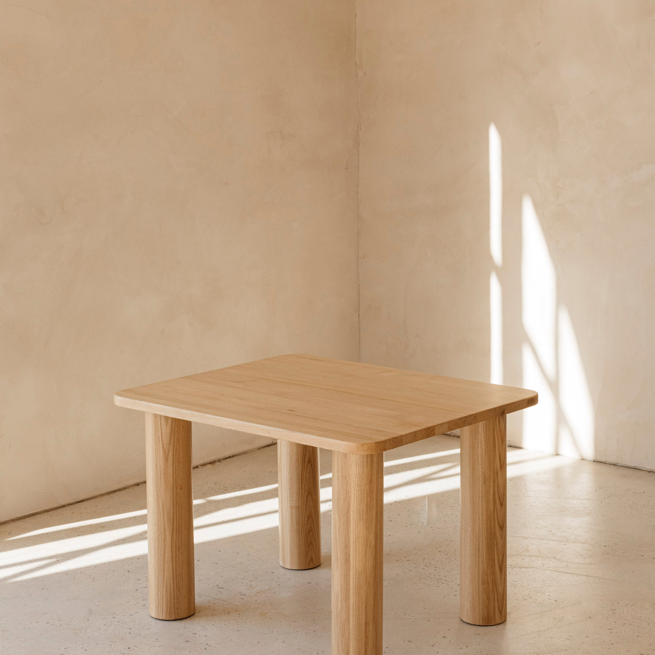 Hennie Ashwood Kids Table in a sunlit room showing the natural wood grain in the light