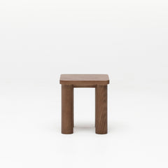 Walnut timber kid's stool with a square top and solid wood legs on a white background
