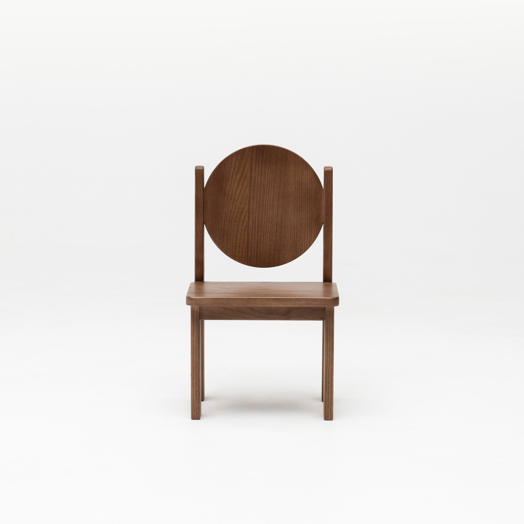 Front view of Hennie Kids Chair in Walnut showing round circle backrest