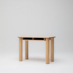 Side angle view of children's study desk in ashwood timber showing paper storage and solid round legs