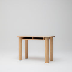 Side angle view of children's study desk in ashwood timber showing paper storage and solid round legs