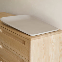 The Leander Matty Mini Change Mat - Cappuccino sitting on top of the Sacred Bundle Arche Ashwood Buffet