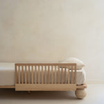 Zali Ashwood Toddler Bed Side Rail on a single bed with mattress in a light beige room