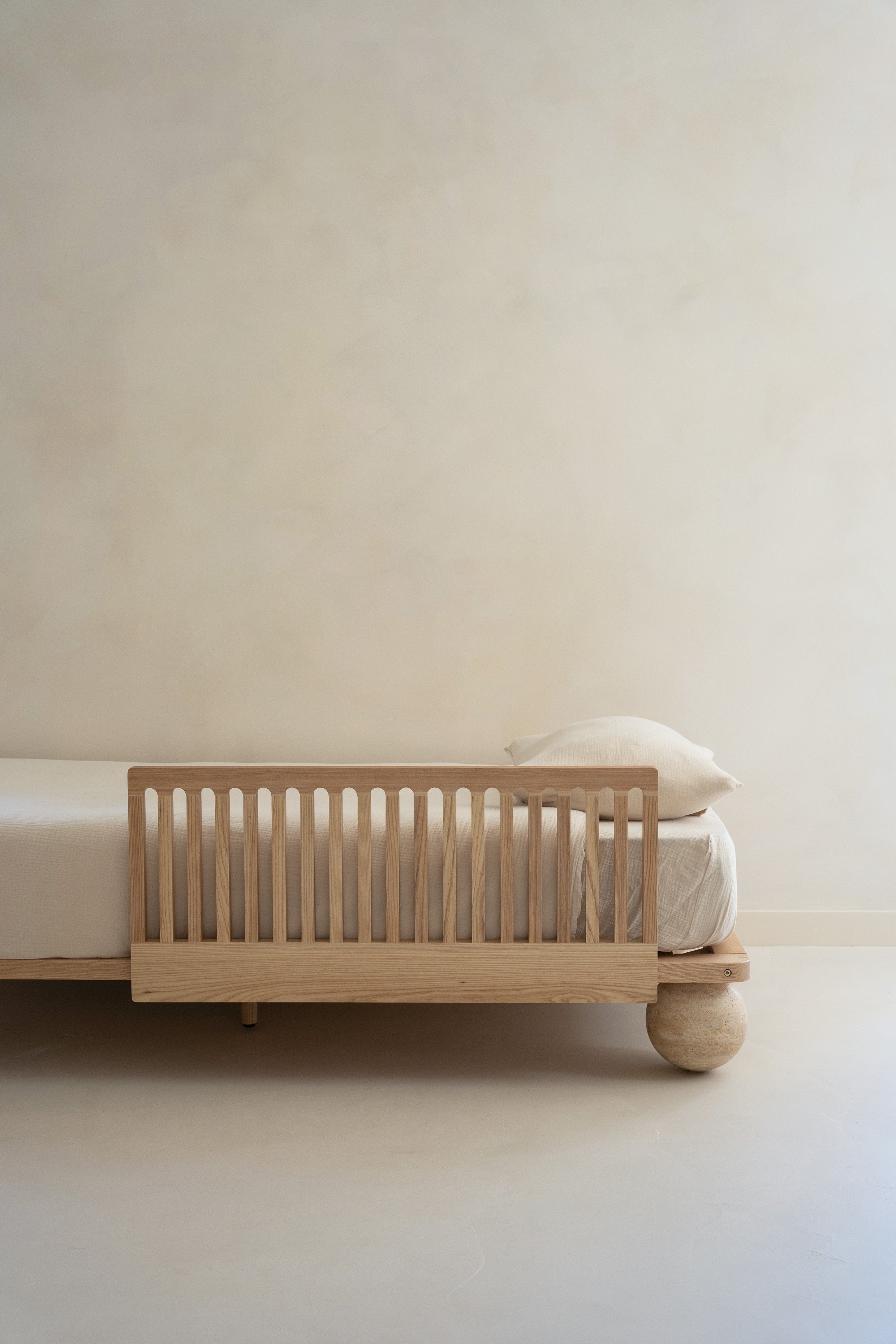 Zali Ashwood Toddler Bed Side Rail on a single bed with mattress in a light beige room