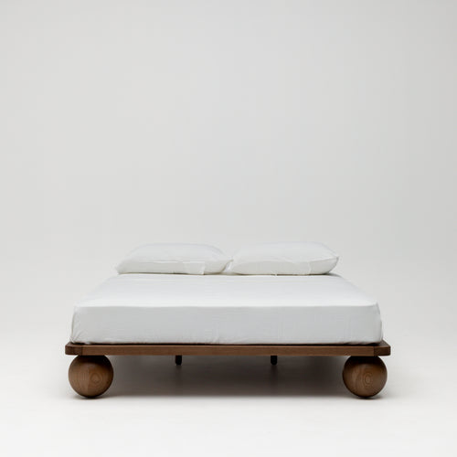 Zali walnut wood children's double bed with rounded ball legs.
