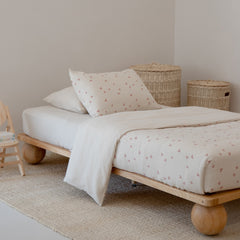 The Zali King Single Bed Ashwood in a light child's bedroom with Sacred Bundle Strawberry Fields duvet cover and Palma Storage baskets