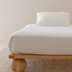 Zali King Single Bed Ashwood in a studio on light background with single mattress and white duvet set