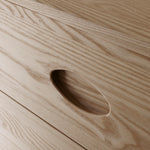 Close up of natural wood grain on front of buffet drawers