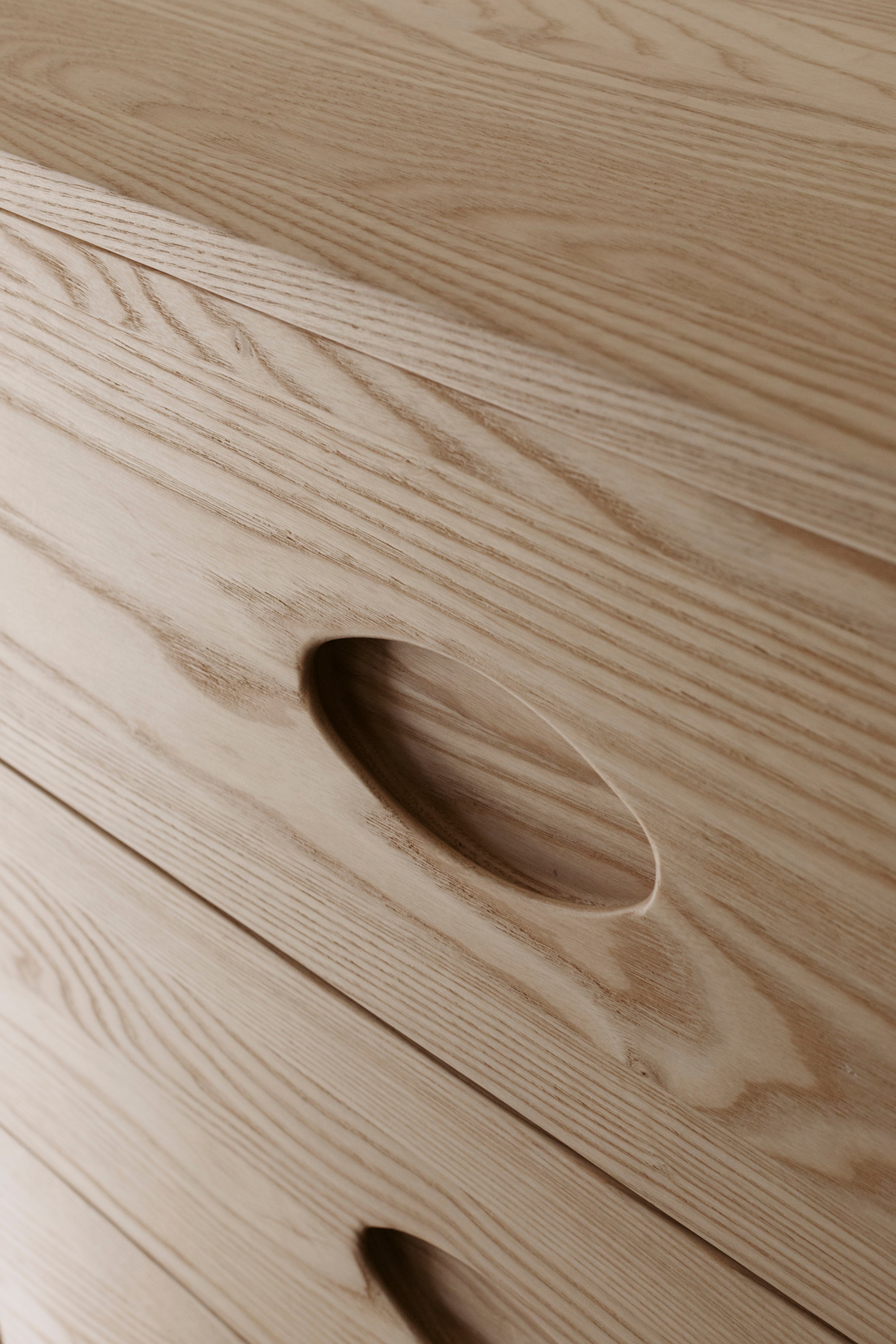 Close up of natural wood grain on front of buffet drawers